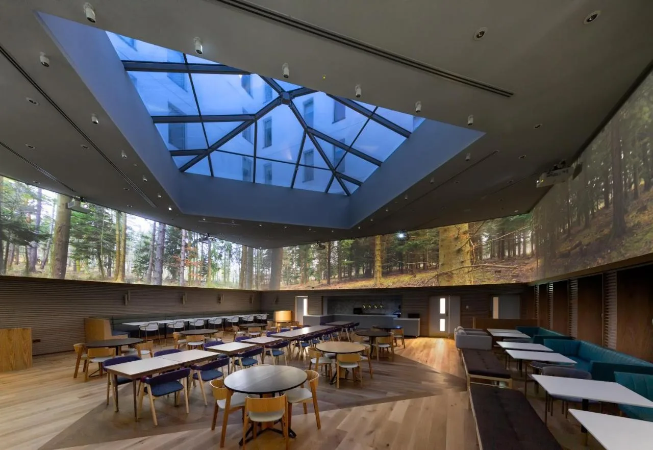 a restaurant with tables and chairs and a large skylight at Yotel Edinburgh in Edinburgh
